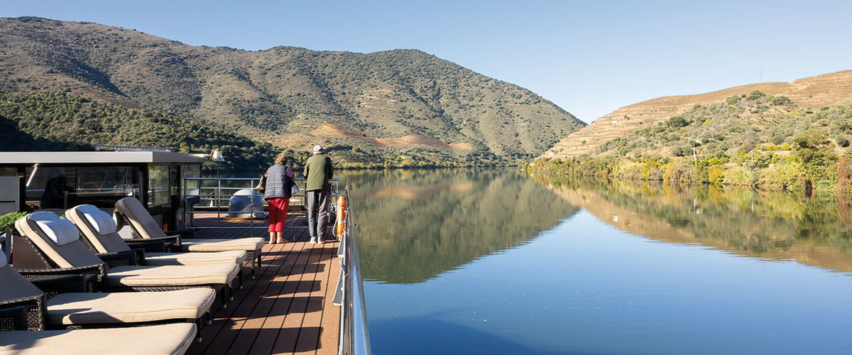 Two people enjoying the view from the Sun Deck on Douro Serenity